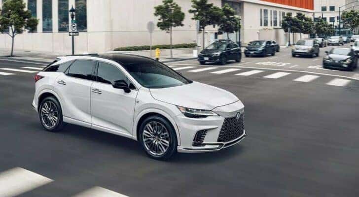 A white 2022 Lexus RX is shown on a city street.