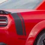 A red 2023 Dodge Challenger Scat Pack is shown from the rear at an angle after leaving a dealer that has cars for sale in Little Rock.