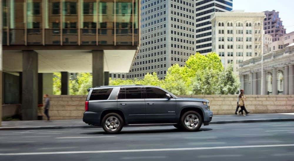 A grey 2020 Chevy Tahoe Premier Plus is shown from the side after looking at cars for sale in Minneapolis.