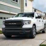 A white 2022 Ram 1500 Tradesman is shown from the front at an angle after leaving a dealer that has cars for sale in Oklahoma City.
