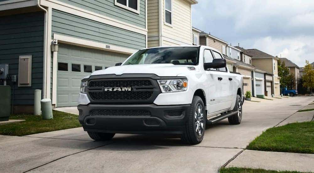 A white 2022 Ram 1500 Tradesman is shown from the front at an angle after leaving a dealer that has cars for sale in Oklahoma City.