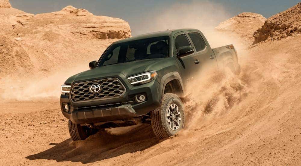 A green 2021 Toyota Tacoma is shown from the front at an angle.
