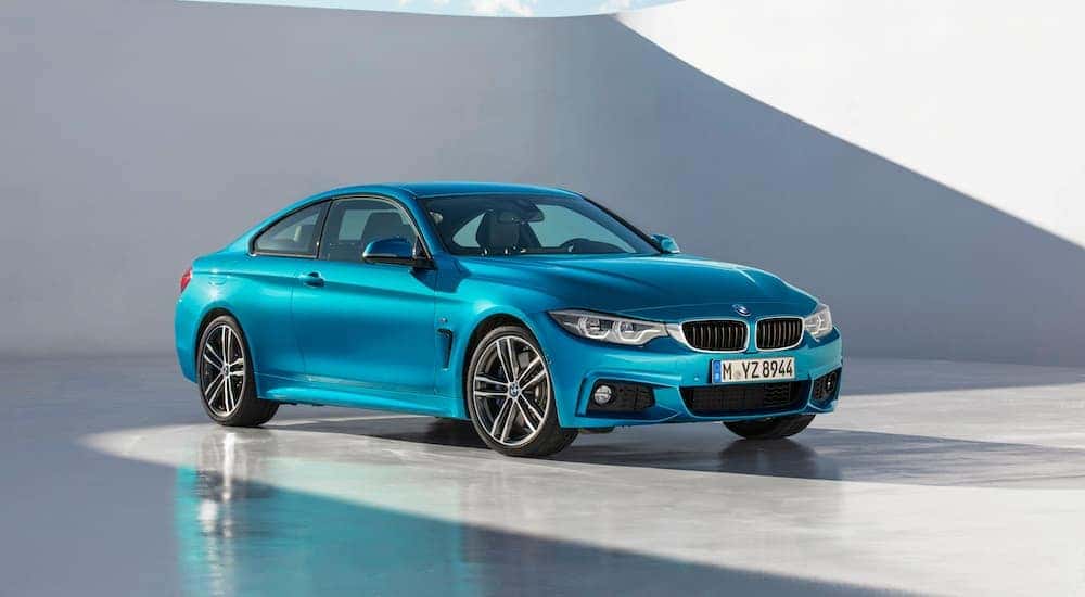A blue 2019 BMW 4-Series 430i is shown parked in the daylight.