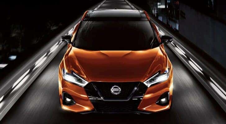An orange 2021 Nissan Maxima is shown from the front after leaving a dealer that has cars for sale in Albuquerque.