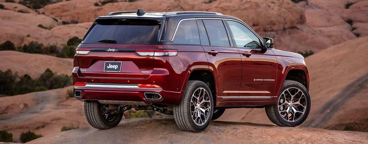 A red 2022 Jeep Grand Cherokee is shown from the rear at an angle.