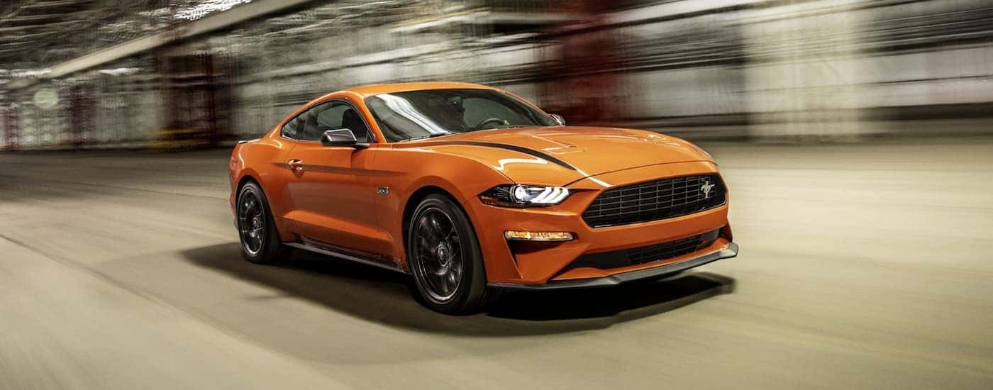 An orange 2021 Ford Mustang EcoBoost HPP is shown from the front at an angle.