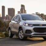 A silver 2021 Chevy Trax is shown from the front at an angle after leaving a dealer that has a used Chevy Trax for sale.