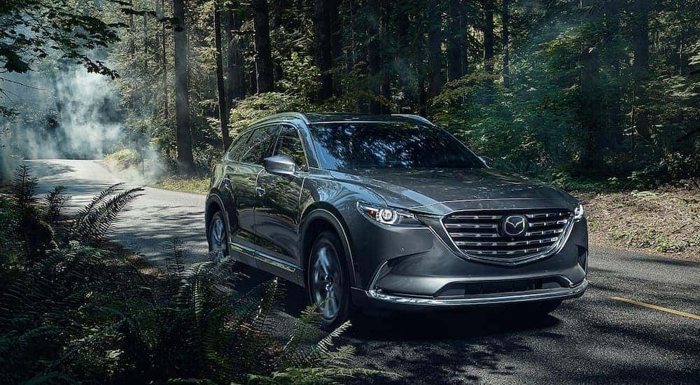A silver 2021 Mazda CX-9 is shown from the front at an angle after leaving a dealer that handles Fort Worth SUV sales.