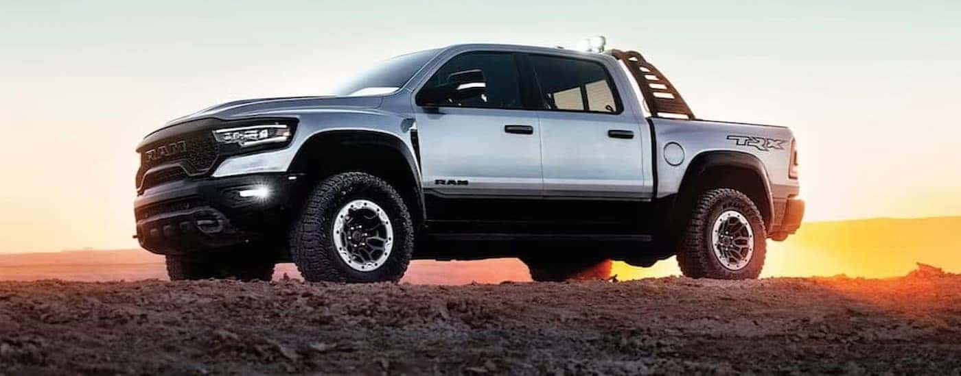 A silver 2023 Ram 1500 TRX is shown parked off-road.