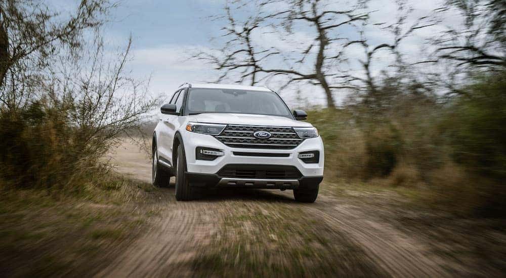 A white 2021 Ford Explorer King Ranch is shown from the front on a trail.