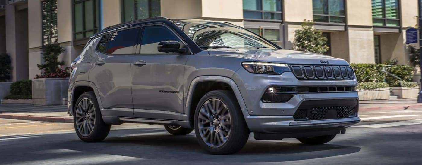 A silver 2022 Jeep Compass is shown on city street after looking at Nashville car sales.