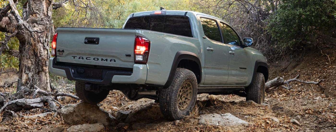 A grey 2022 Toyota Tacoma SR5 is shown from the rear off-roading.