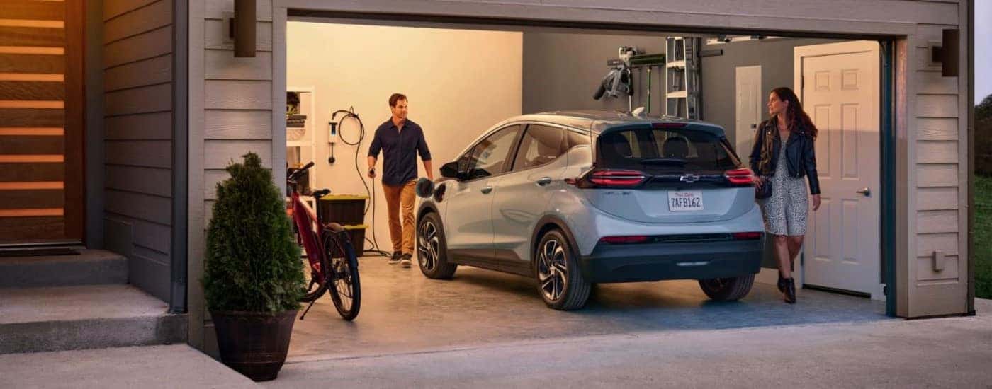 A silver 2022 Chevy Bolt EV is shown from the rear parked in a garage.