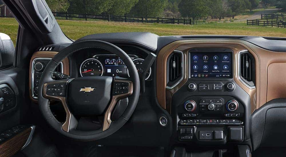 The black and brown interior and dash of a 2021 Chevy Silverado 1500 is shown.