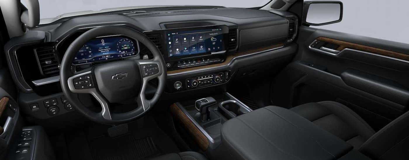 The black and brown interior and dash of a 2023 Chevy Silverado 1500 RST is shown.