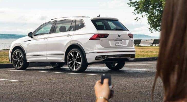 A white 2022 Volkswagen Tiguan is shown from the rear at an angle.