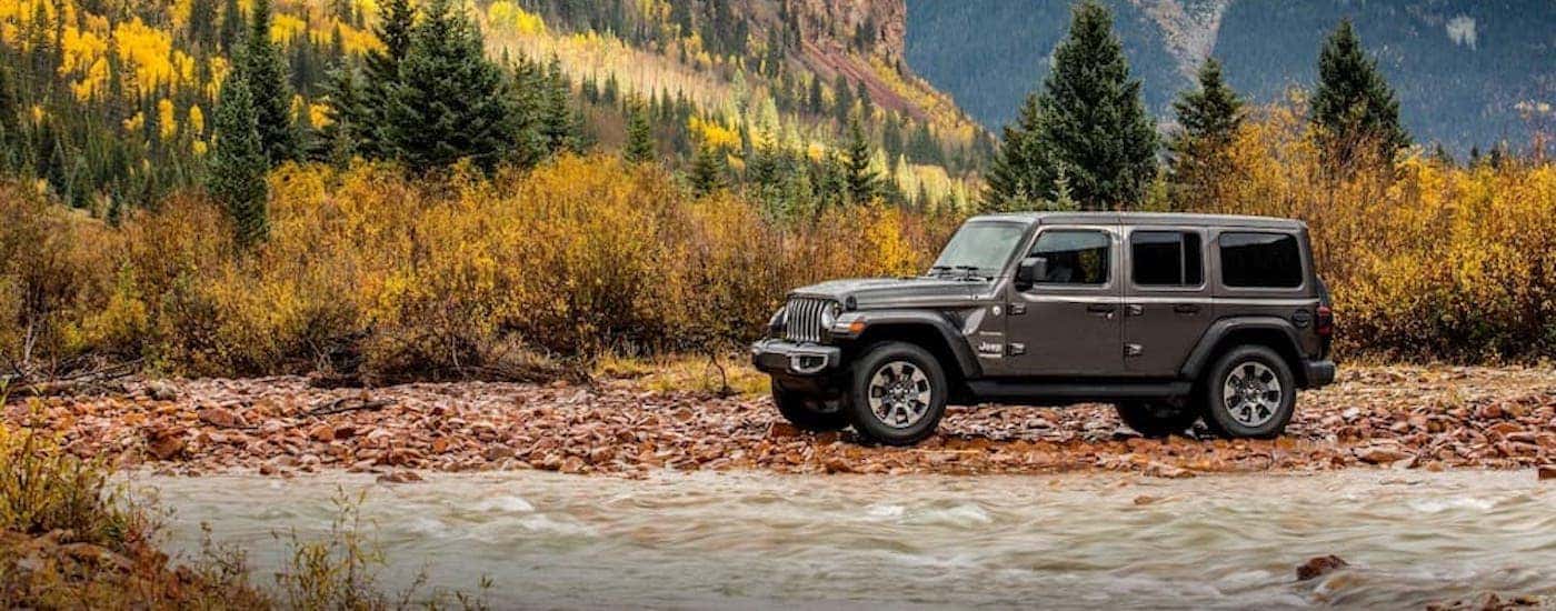 A gray 2018 Jeep Wrangler Unlimited is shown parked on rocks.