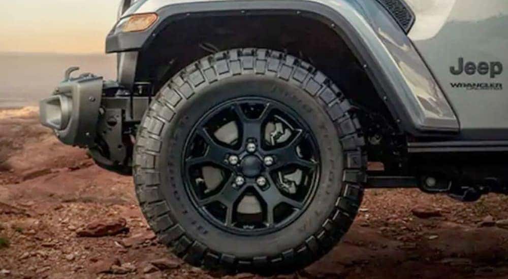 A close-up of a wheel on a 2018 Jeep Wrangler is shown.