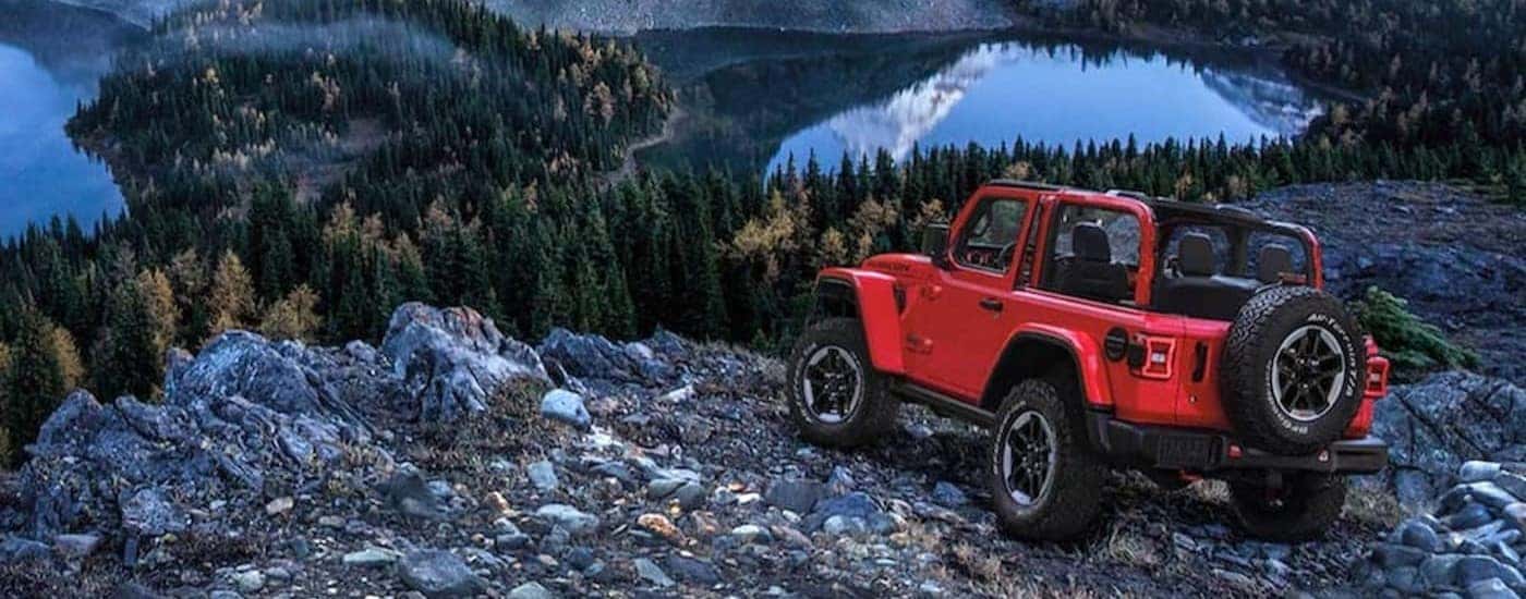 A red 2020 Jeep Wrangler Rubicon is shown parked near a cliff.