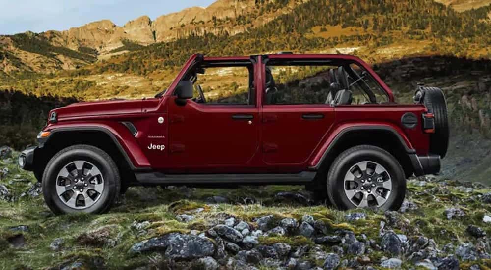 A maroon 2022 Jeep Wrangler is shown from the side.