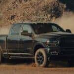A black 2022 Ram 2500 Cummins is shown from the front at an angle after leaving a dealer that handles Cincinnati truck sales.