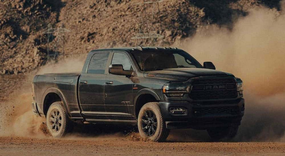 A black 2022 Ram 2500 Cummins is shown from the front at an angle after leaving a dealer that handles Cincinnati truck sales.