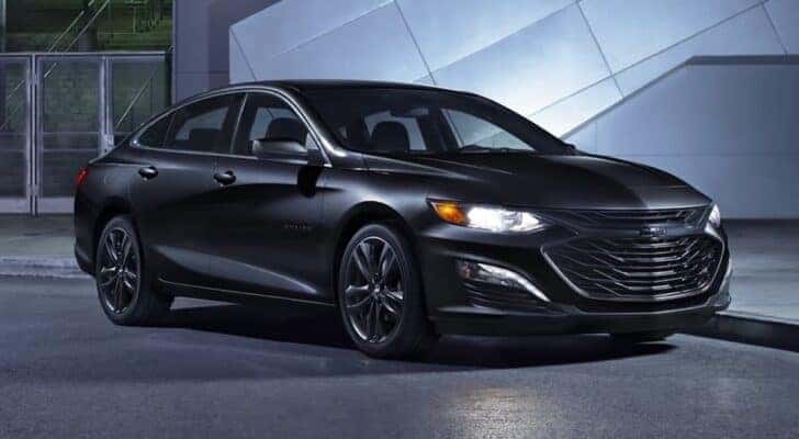 Available in Cincinnati car sales, a black 2024 Chevy Malibu Midnight Edition, is shown parked.