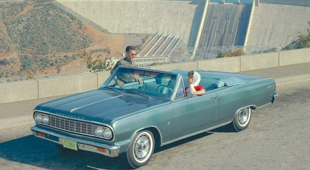A blue 1964 Chevy Malibu Convertible is shown from the front at an angle.