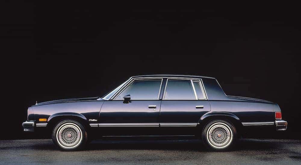 A black 1983 Chevy Malibu is shown from the side.