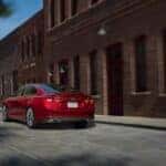 A red 2021 Chevy Malibu for sale is shown from the rear at an angle.