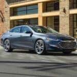 A grey 2019 Chevy Malibu for sale is shown from the front at an angle.