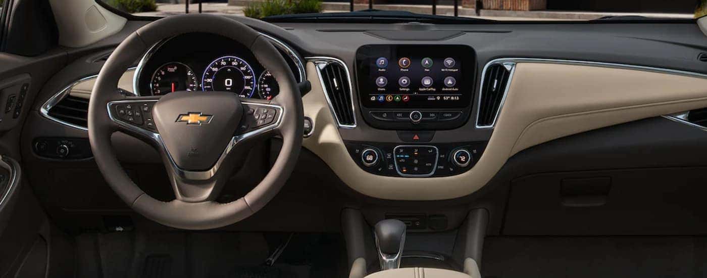 The gray and tan interior and dash of a 2022 Chevy Malibu is shown.