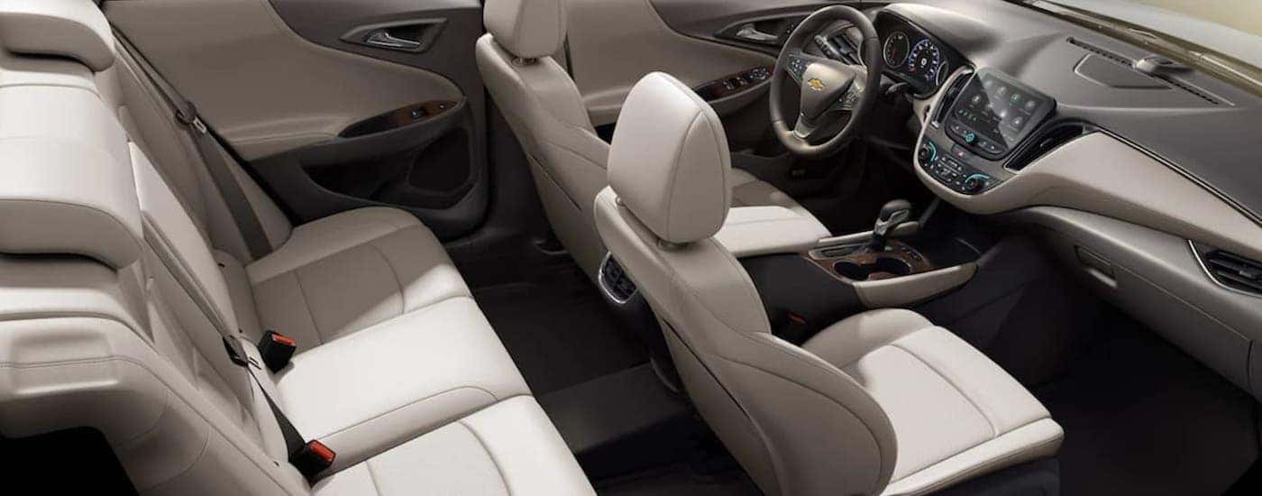 The white and gray interior and dash of a 2022 Chevy Malibu is shown.