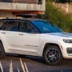 A white 2023 Jeep Grand Cherokee is shown from the front at an angle after browsing Dayton SUV sales.