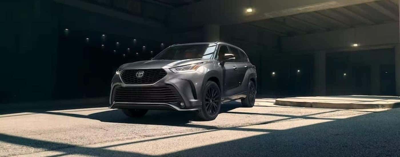 A gray 2023 Toyota Highlander is shown parked in a parking garage.