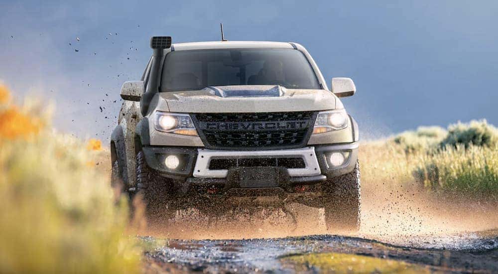 A tan 2022 Chevy Colorado ZR2 Bison is shown driving off-road.