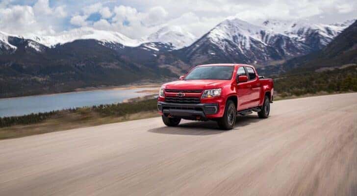 A red 2022 Chevy Colorado for sale is shown driving.