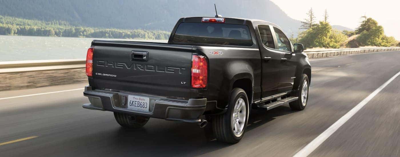 A black 2022 Chevy Colorado LT is shown from a rear angle while driving.