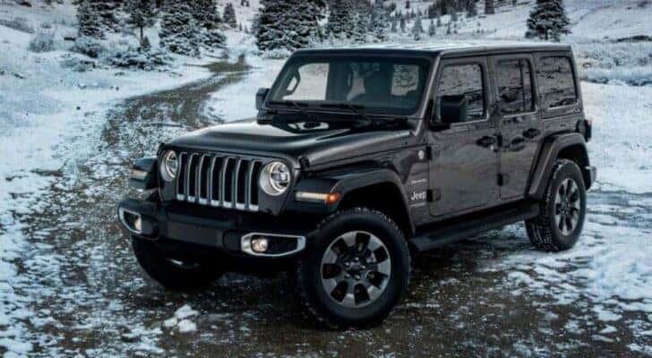 A black 2020 Jeep Wrangler Unlimited is shown parked off-road after visiting a dealer with a Jeep Wrangler for sale in Nashville.