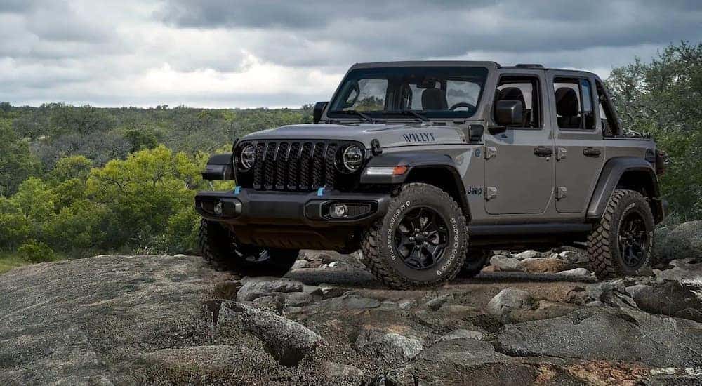 A gray 2022 Jeep Wrangler Willys is shown parked off-road.