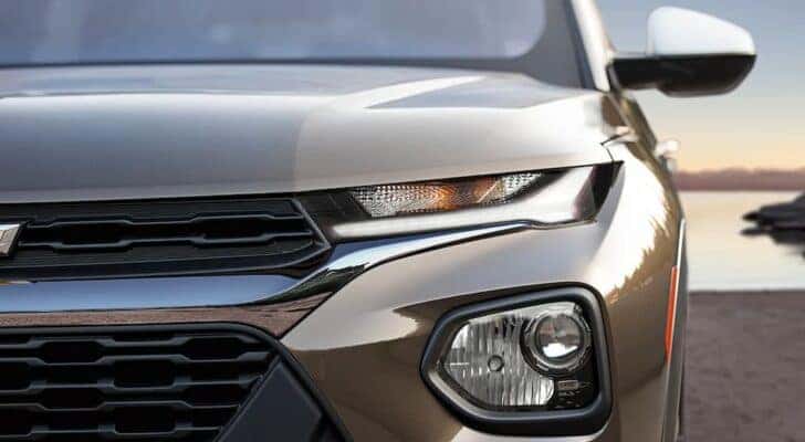 A close up of the headlight on a brown 2022 Chevy Trailblazer for sale.