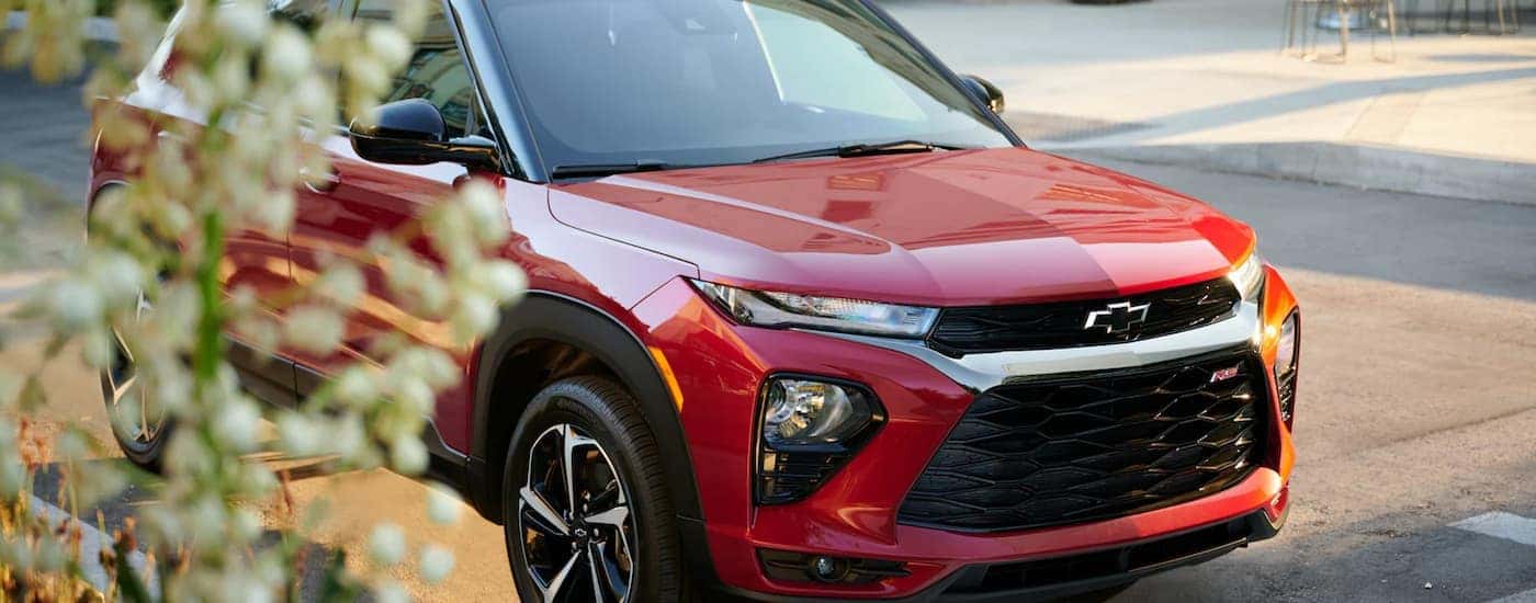 A red 2023 Chevy Trailblazer is parked on the side of a city street.
