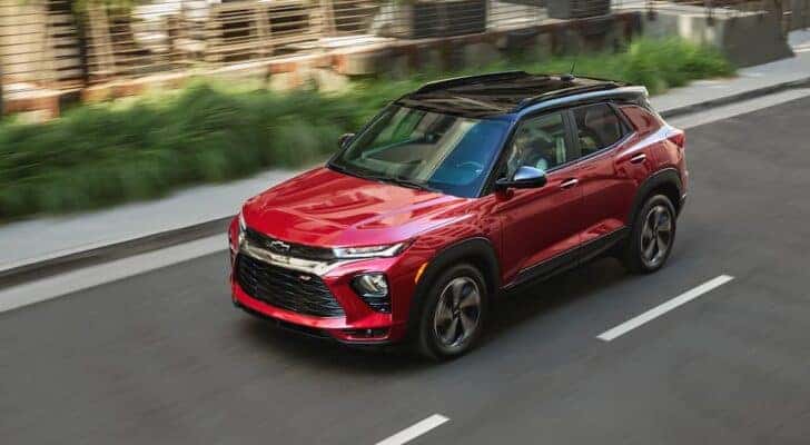 A red 2021 Chevy Trailblazer is shown driving after visiting a dealer with a used Chevy Trailblazer for sale.