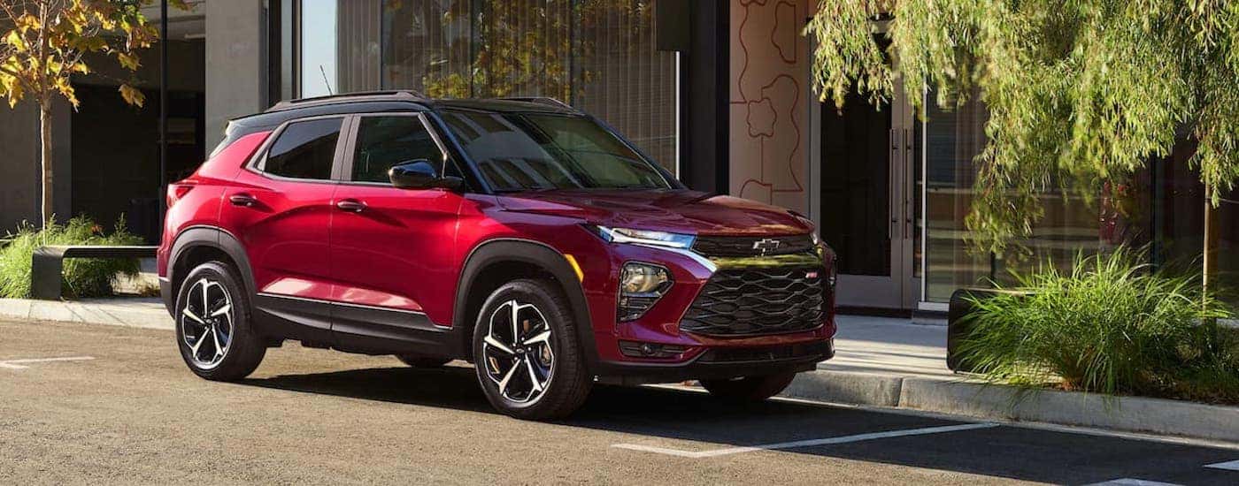 A red 2021 Chevy Trailblazer RS angled right and parked by a curb.