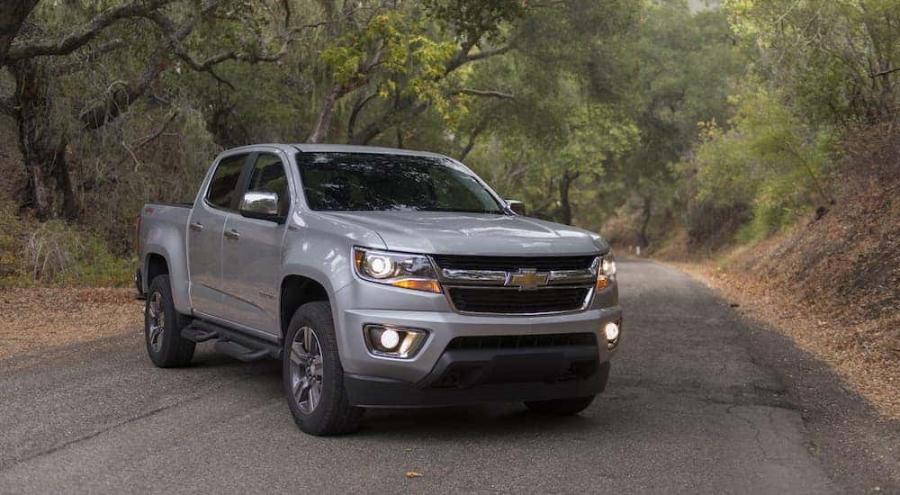 A silver 2016 Chevy Colorado is shown parked on a back road.