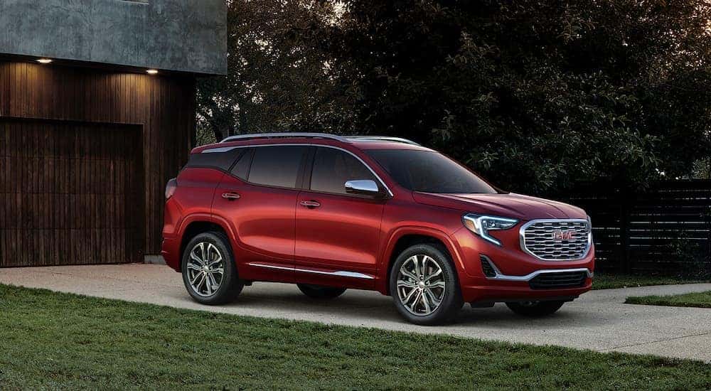 A red 2018 GMC Terrain Denali is shown from the front at an angle.