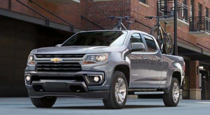 A grey 2021 Chevy Colorado for sale in Louisville is parked on a city street.