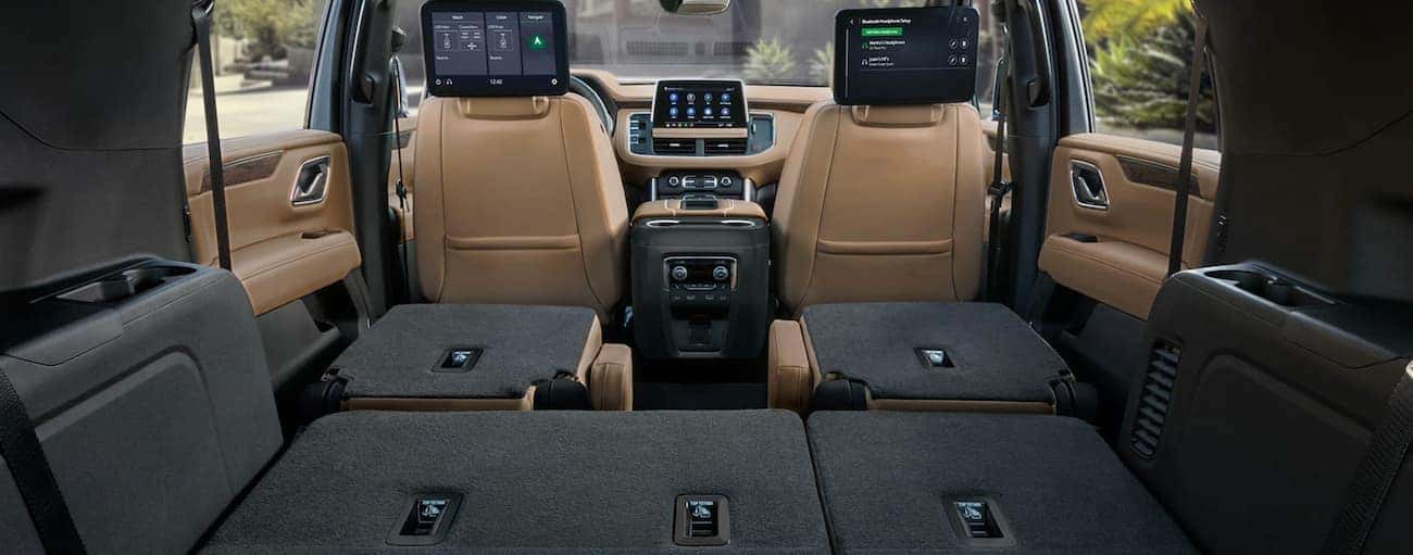 The interior seating and rear entertainment screens in a 2021 Chevy Tahoe for sale.