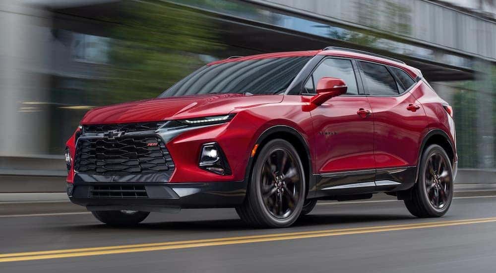 A red 2020 Chevy Blazer RS is shown driving on a city street.