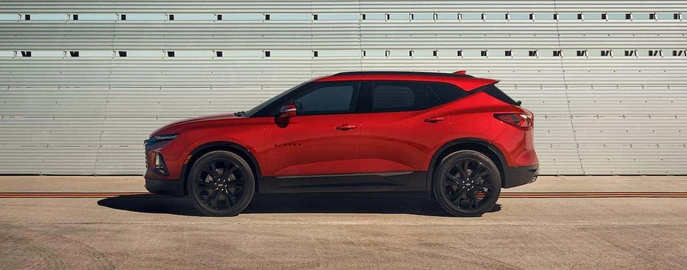 A red 2021 used Chevy Blazer for sale is shown from the side.